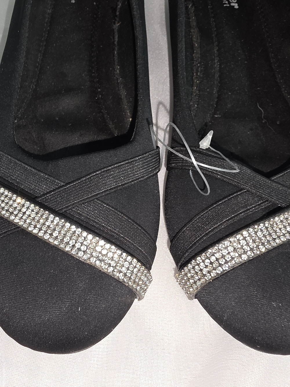 Forever Comfort black wedge pumps featuring criss-cross straps